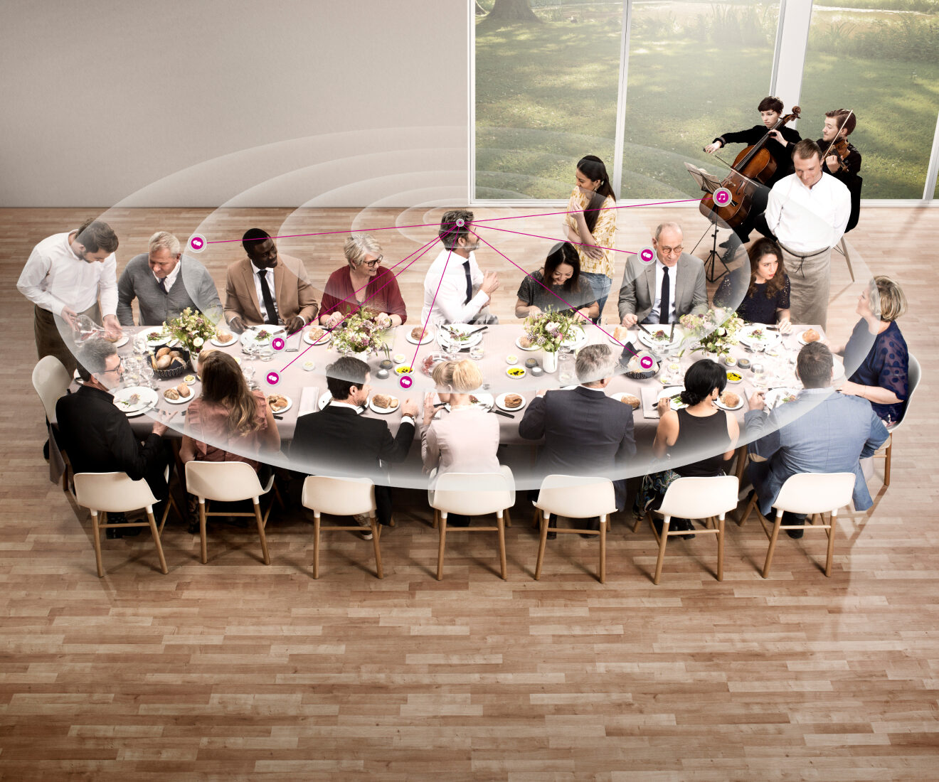 Guests dining at a long table with musicians nearby.