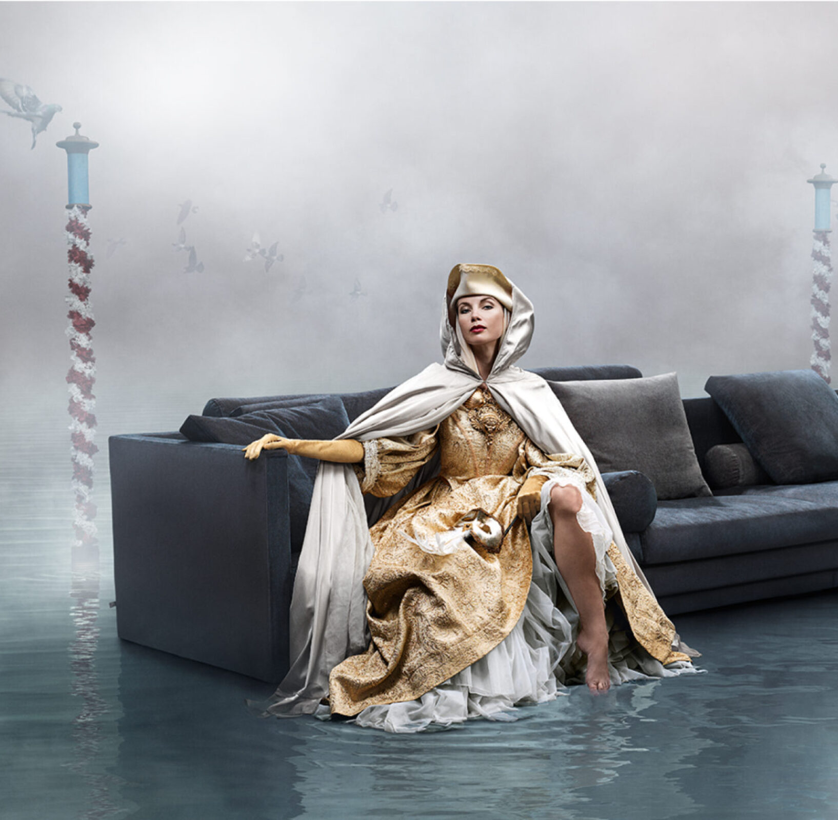 A woman sitting on a Eilersen sofa in the water.