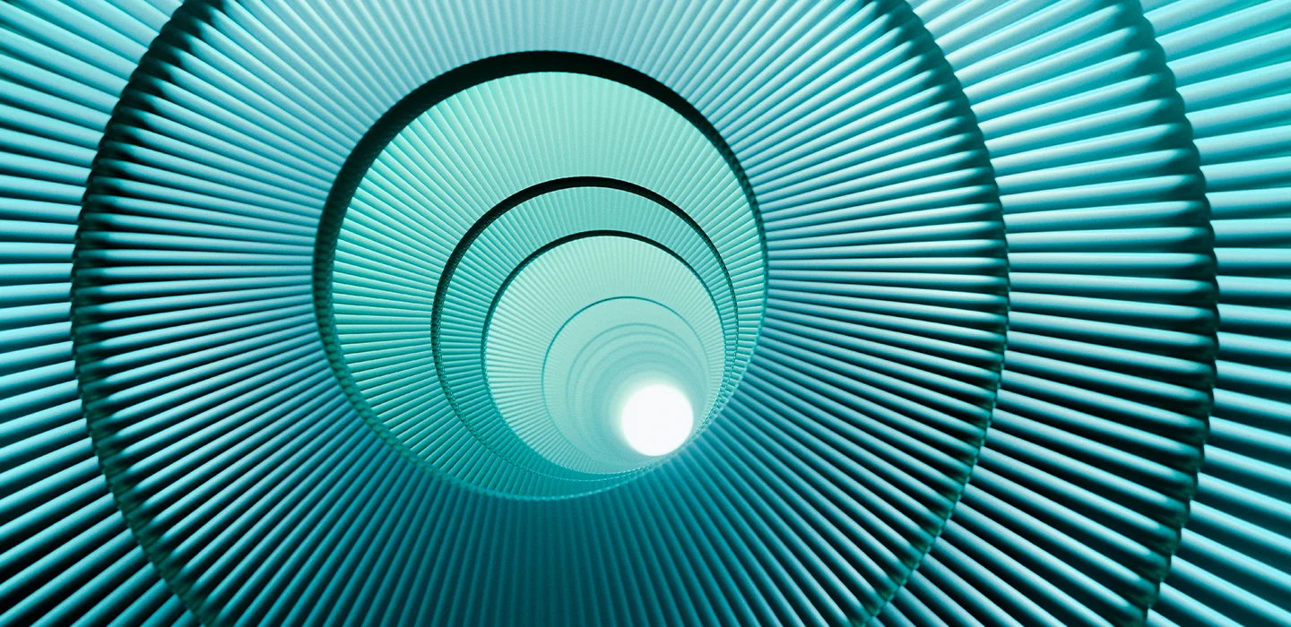 A turquoise ribbed tunnel leading to a bright circular opening.