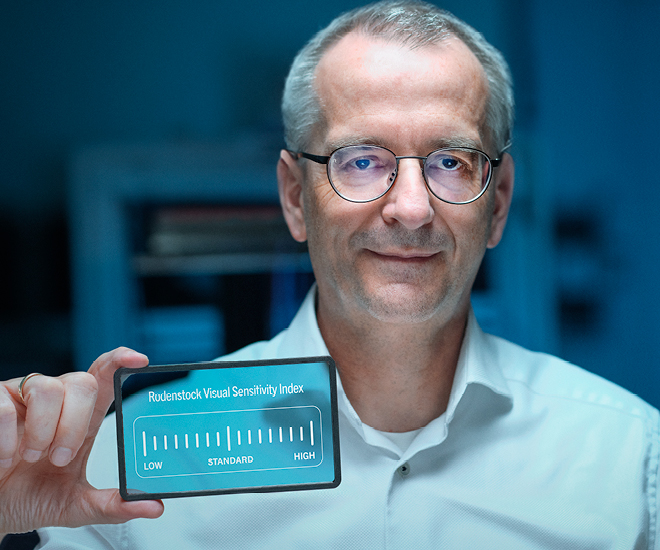 Man holding a Rodenstock Visual Sensitivity Index card.