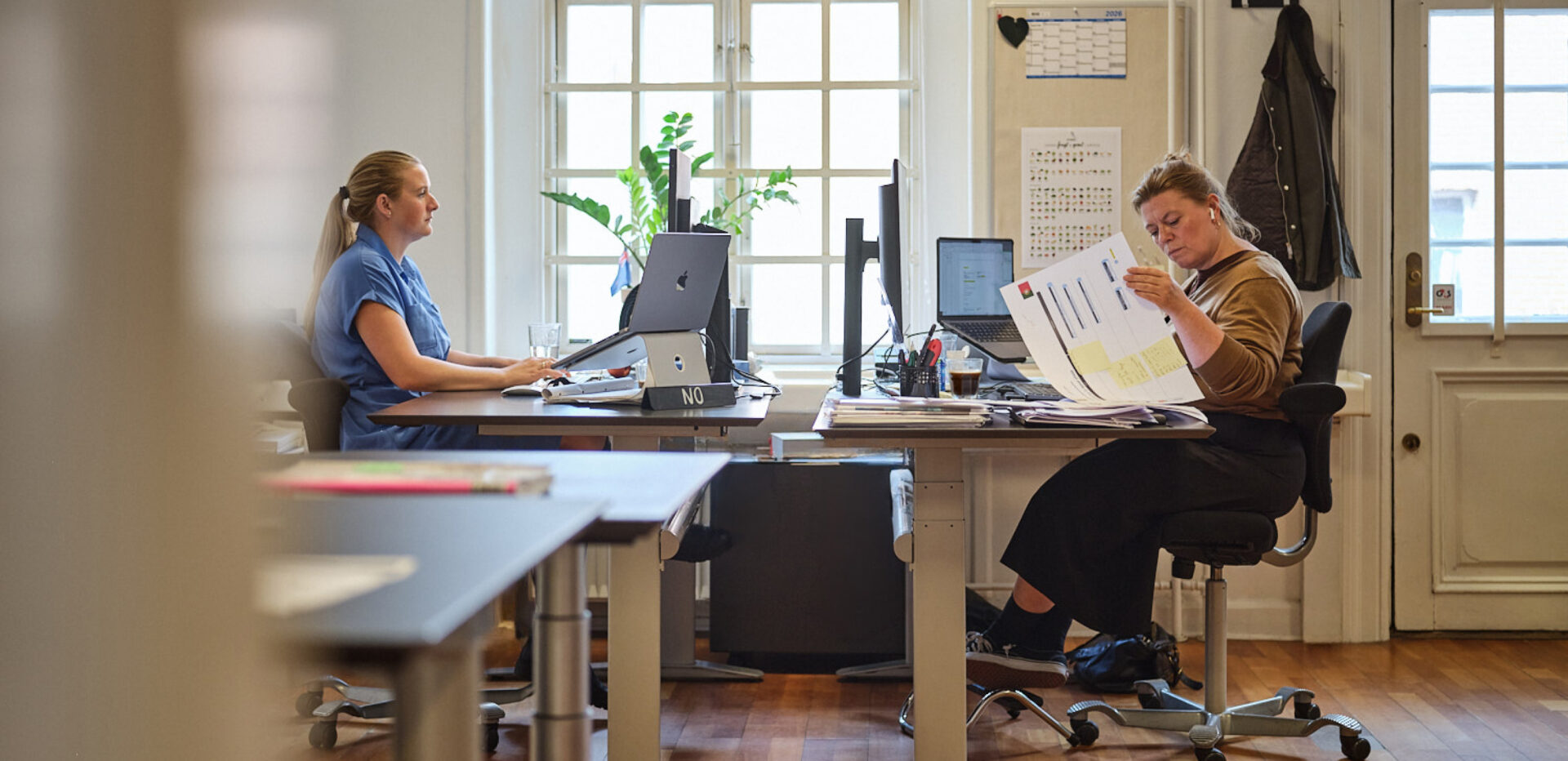 Employees sitting at their desks.