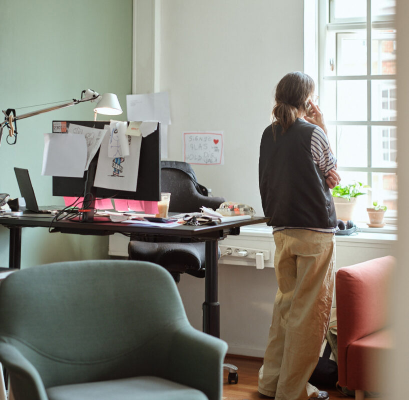 An employee looking out of an office window.